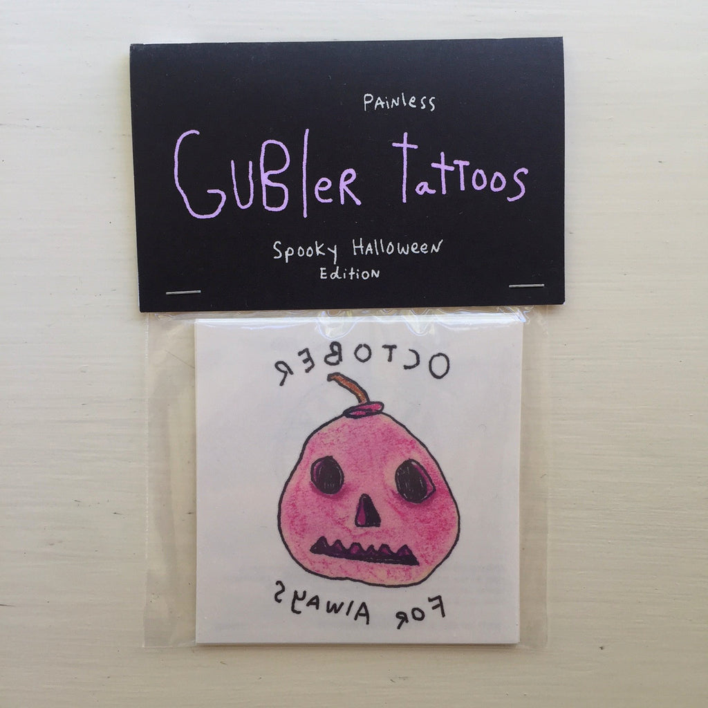 Pink/red hand-drawn jack-o-lantern inside packaging that reads “Painless Gubler Tattoos: Spooky Halloween Edition”.