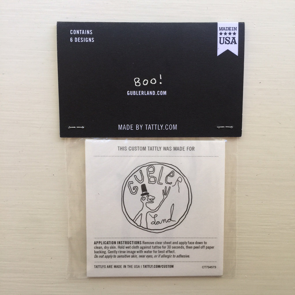 Backside of temporary tattoo packaging with the hand drawn Gublerland logo.