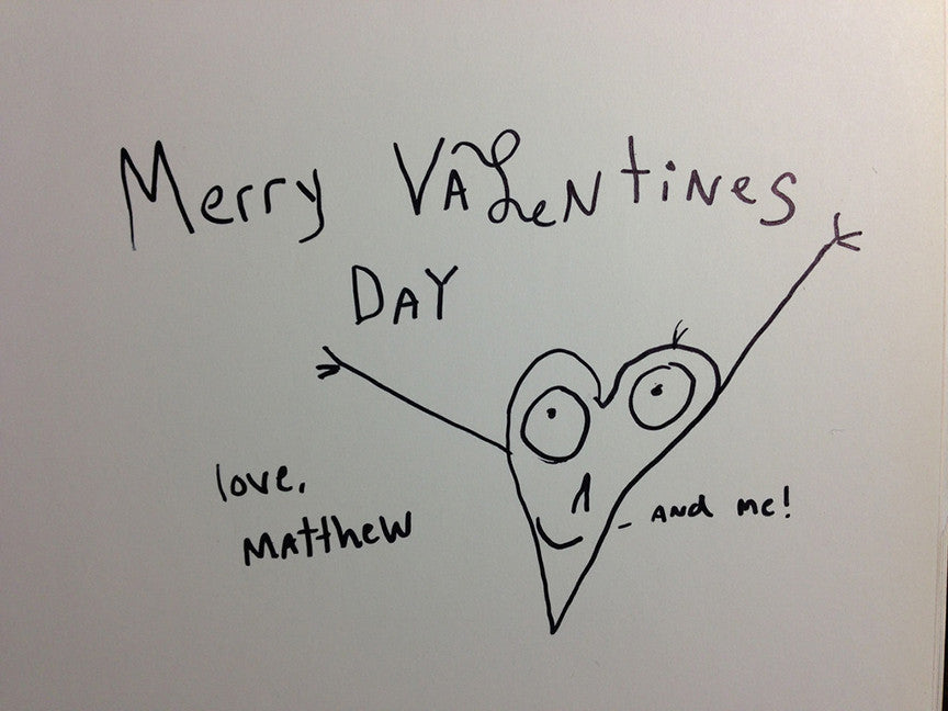 Note card with hand-drawn hear with arms and handwritten text thats says “Merry Valentines Day” Love, Matthew