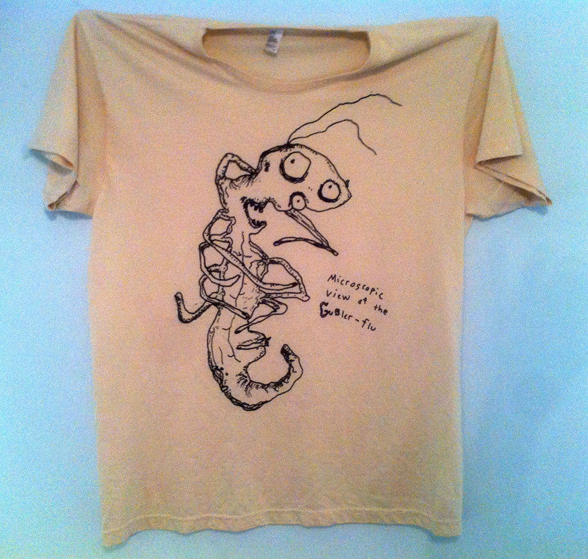 Tan colored t-shirt with hand-drawn creature with written text that says “microscpoic view of the Gubler-flu”.